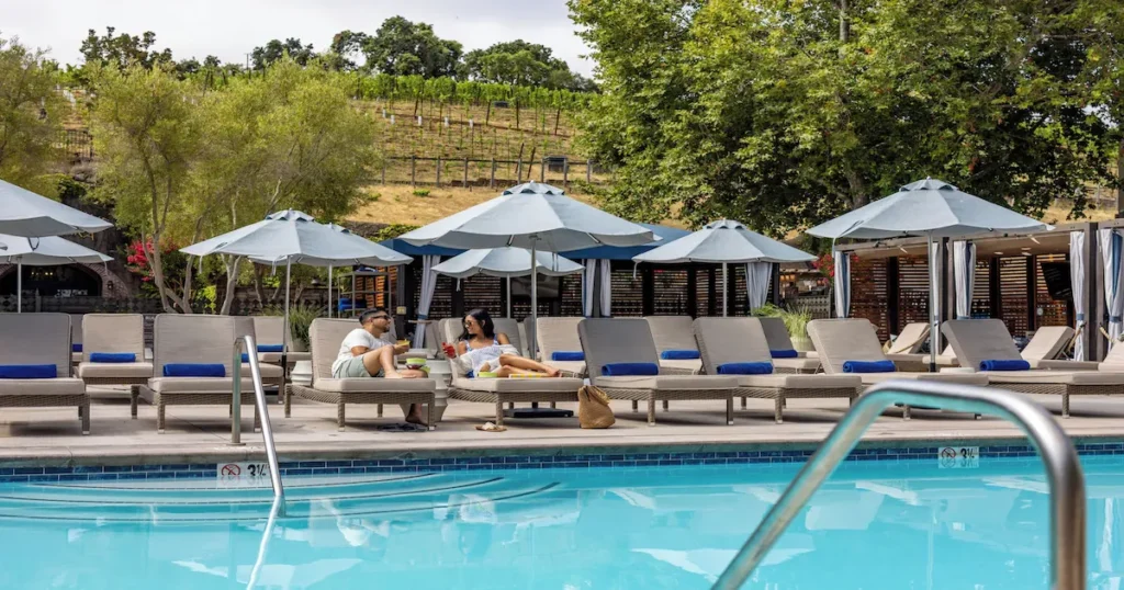 Couple chilling close to the pool at The Meritage Resort and Spa in Napa