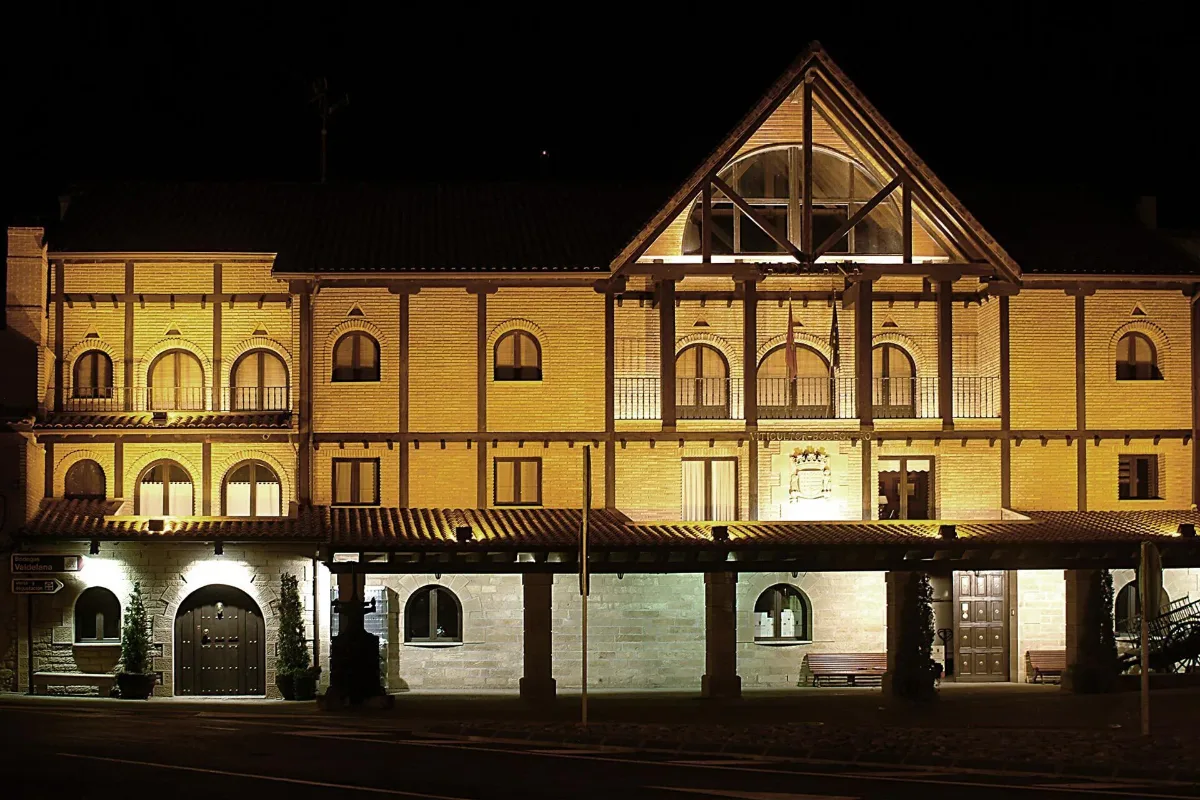 Ornate winery building lit up at night in the village of Elciego, Agroturismo Valdelana