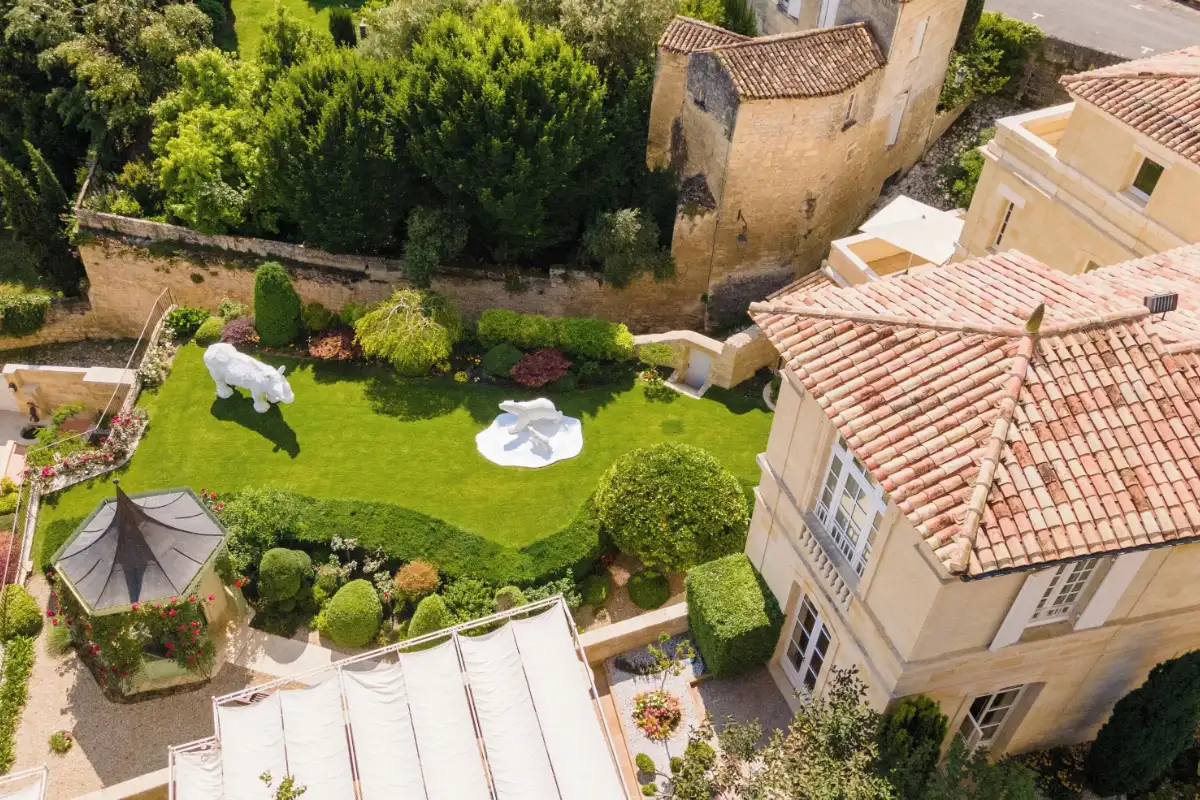 The garden terrace at Hôtel de Pavie above the tiled roofs of the medieval village, the most central answer to where to stay in Saint-Émilion