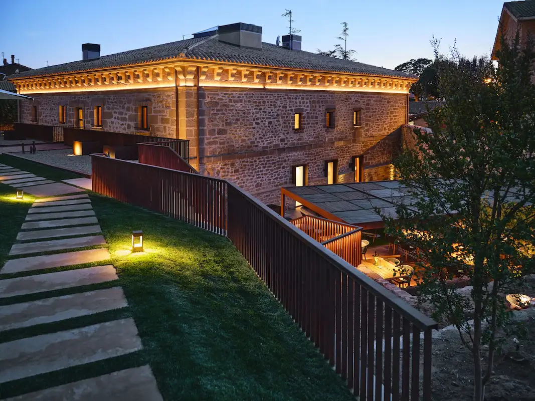 The floodlit stone facade of Hotel Palacio de Samaniego in Rioja Alavesa at dusk
