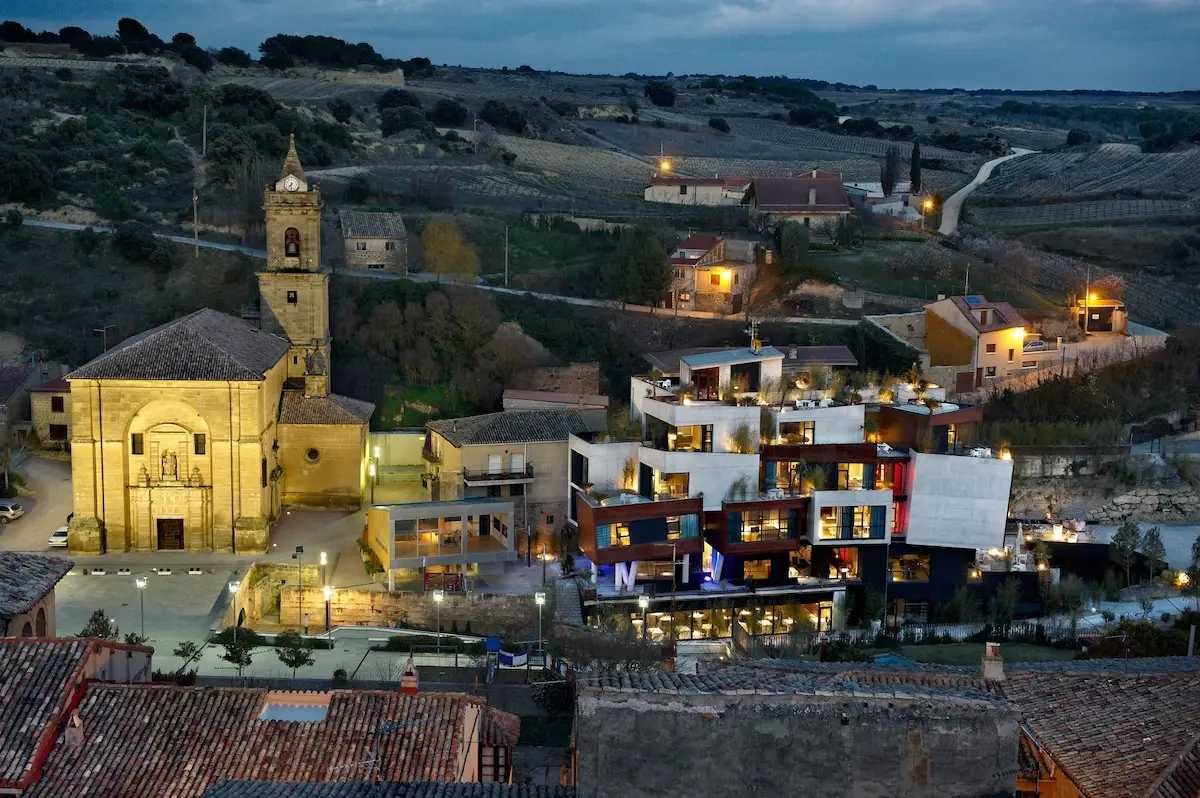 The village of Villabuena de Alava at dusk, its church and vineyards below the roof terrace at Viura