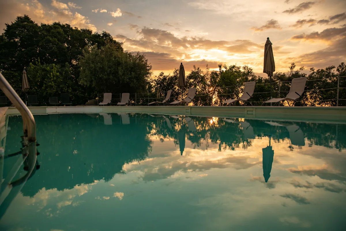 Pool at sunset among the trees of Agriturismo San Leonardello near Giarre