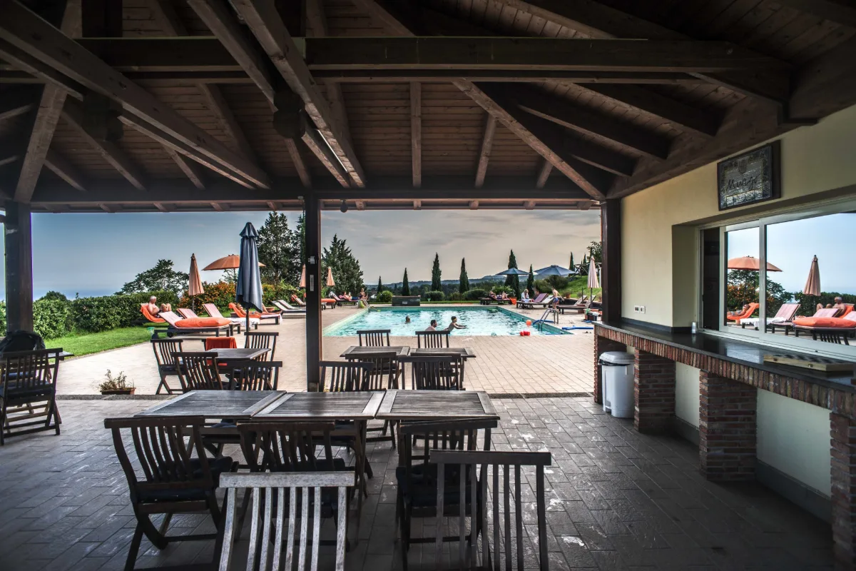 Pool and lawn seen from the covered terrace at Tenuta San Michele, the Murgo family estate in Santa Venerina