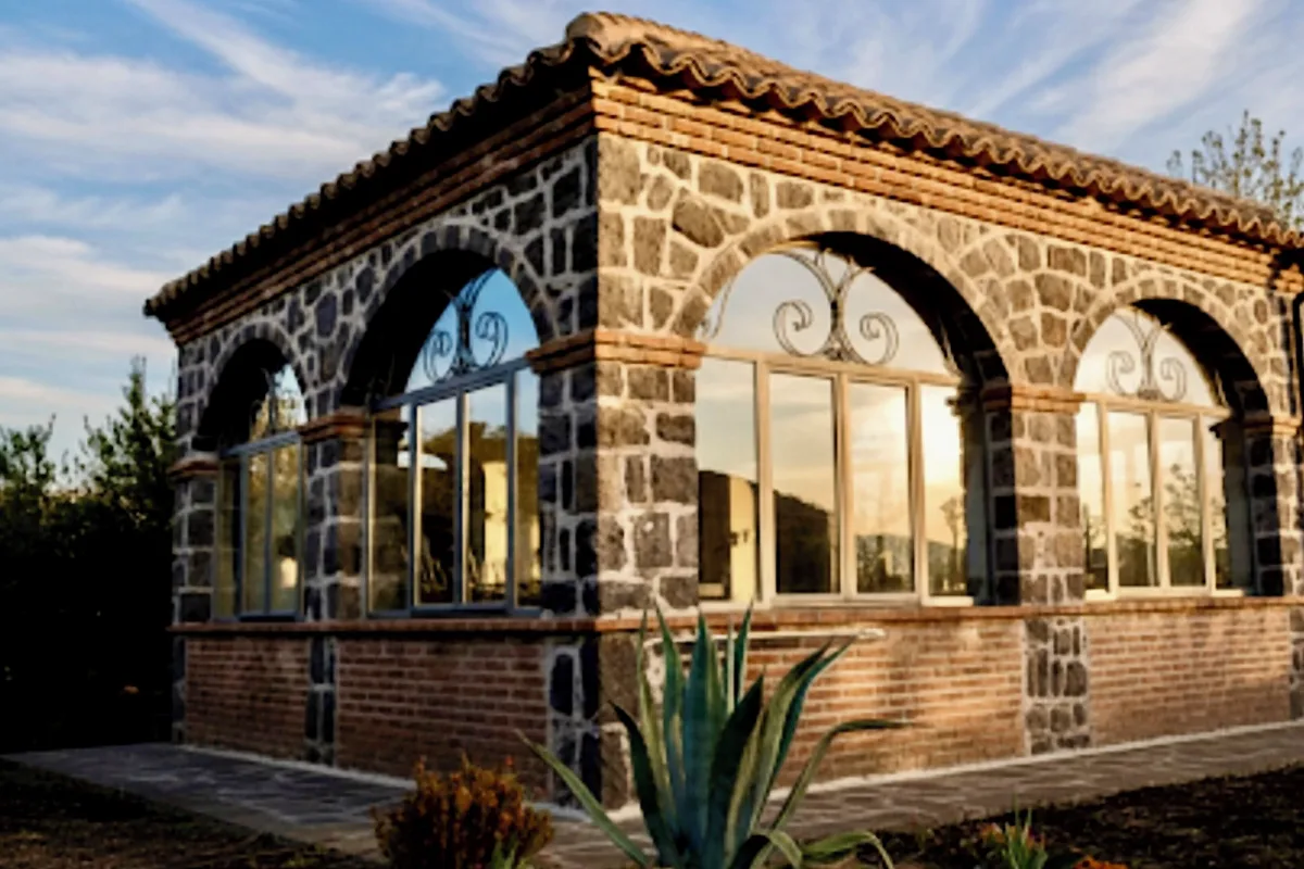 Lava-stone house with tall arched windows at B&B Villa Loriana in Milo, one of the hotels on the Etna east and south slopes