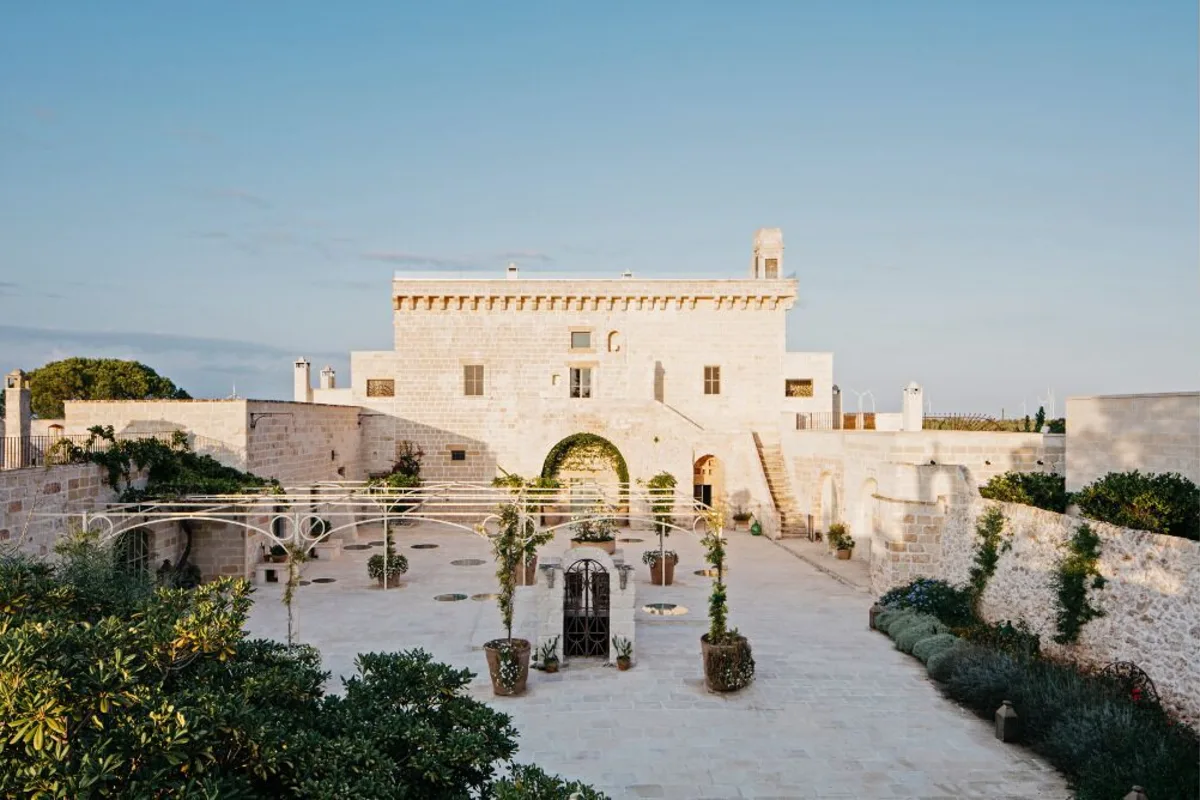 Where to stay in Salento: the stone courtyard and corner tower of Masseria Trapanà outside Lecce