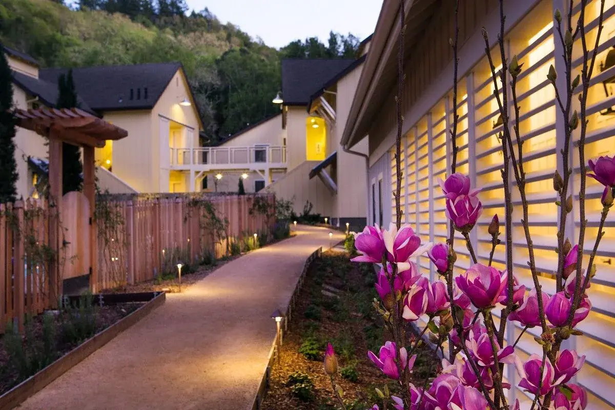 Flower-lined path between the cottages of Farmhouse Inn in Forestville, in the Russian River Valley, at dusk