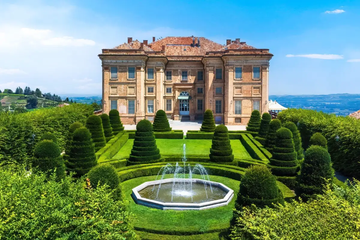 Castello di Guarene's symmetrical facade above a formal garden of clipped hedges and a fountain