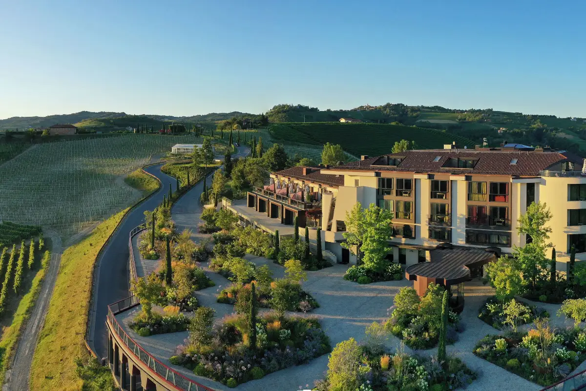 Il Boscareto Resort & Spa, a hillside building above terraced gardens and vineyard slopes near Serralunga d'Alba
